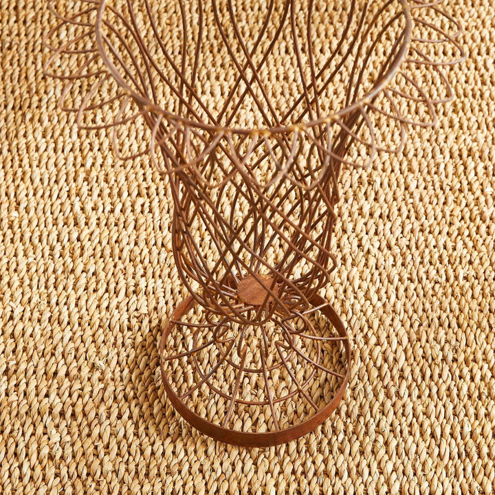 Top-down studio view of weathered wire vase with floral-rimmed edge – Vintage Farmhouse style