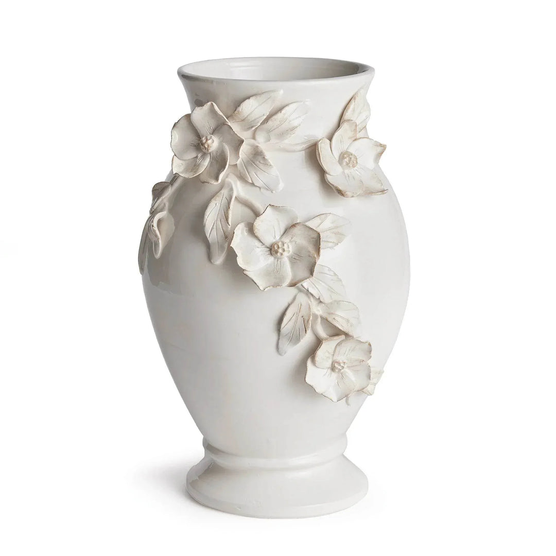 White ceramic floral vase with raised dogwood flowers, a flared opening and footed base, shown alone in Traditional style
