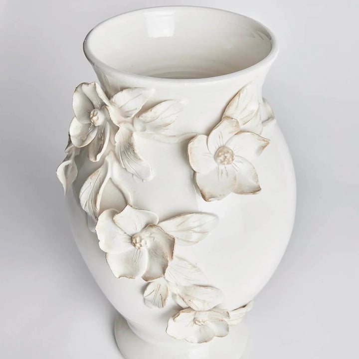 Angled view of a white ceramic vase showing the open neck and hand-applied dogwood flowers and leaves in Traditional style