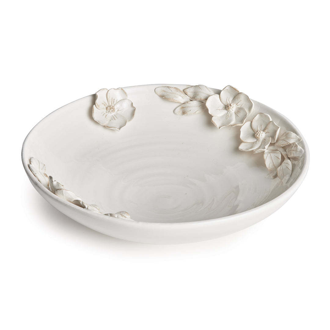 White floral ceramic decorative bowl with a shallow curved profile and raised dogwood flowers, shown in Traditional style