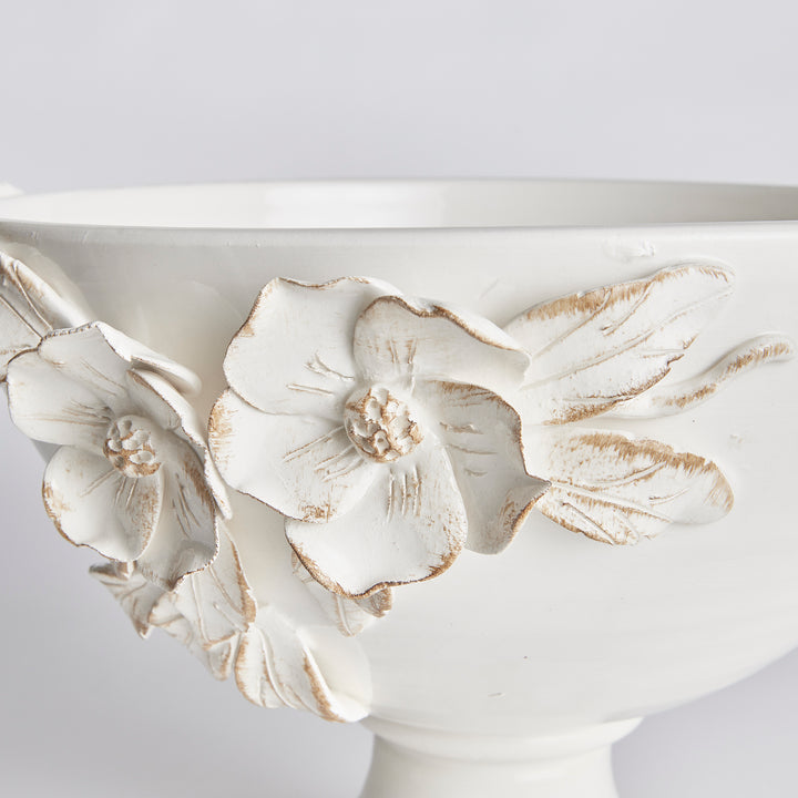 Detail of hand-applied dogwood flowers and leaves on a white ceramic pedestal bowl, with antiqued edges in Traditional style