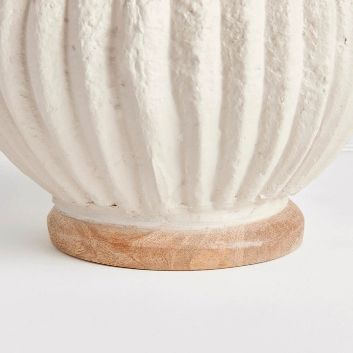 Macro shot of lamp surface showing deep ribbed texture and natural pitting in eco-mix cream finish