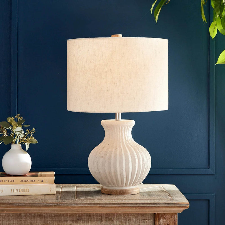 Wabi sabi table lamp styled on wood nightstand with navy wall, highlighting warm ambient light and minimalist design