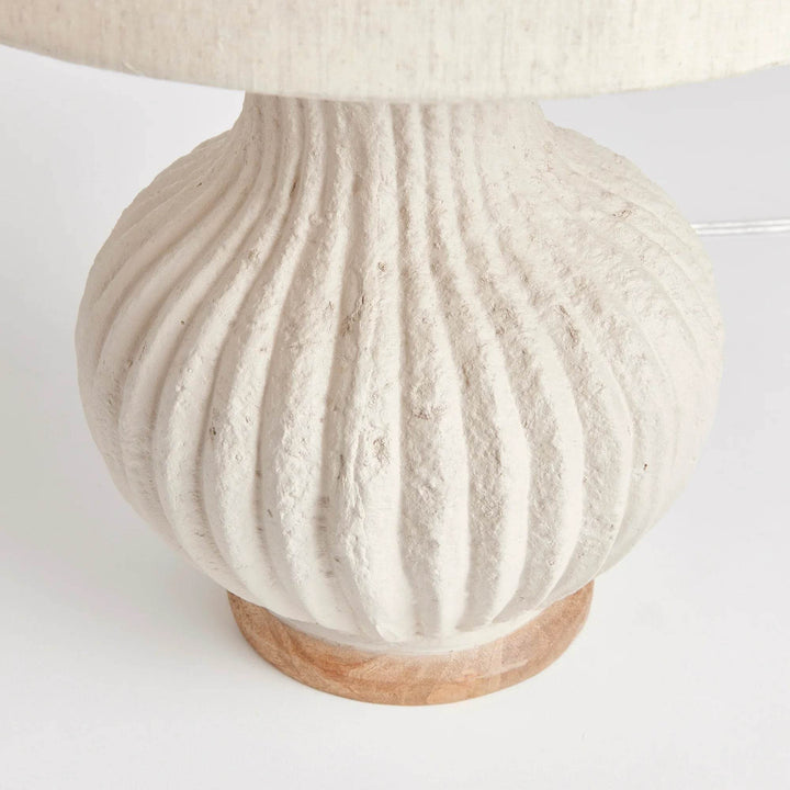 Close-up of ribbed eco-mix lamp base showing handcrafted texture and pitted natural finish in cream