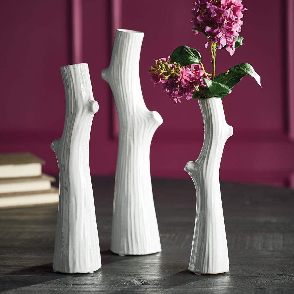 White ceramic faux bois vase trio styled on a dark table with pink flowers, showing the graduated heights - Modern Organic