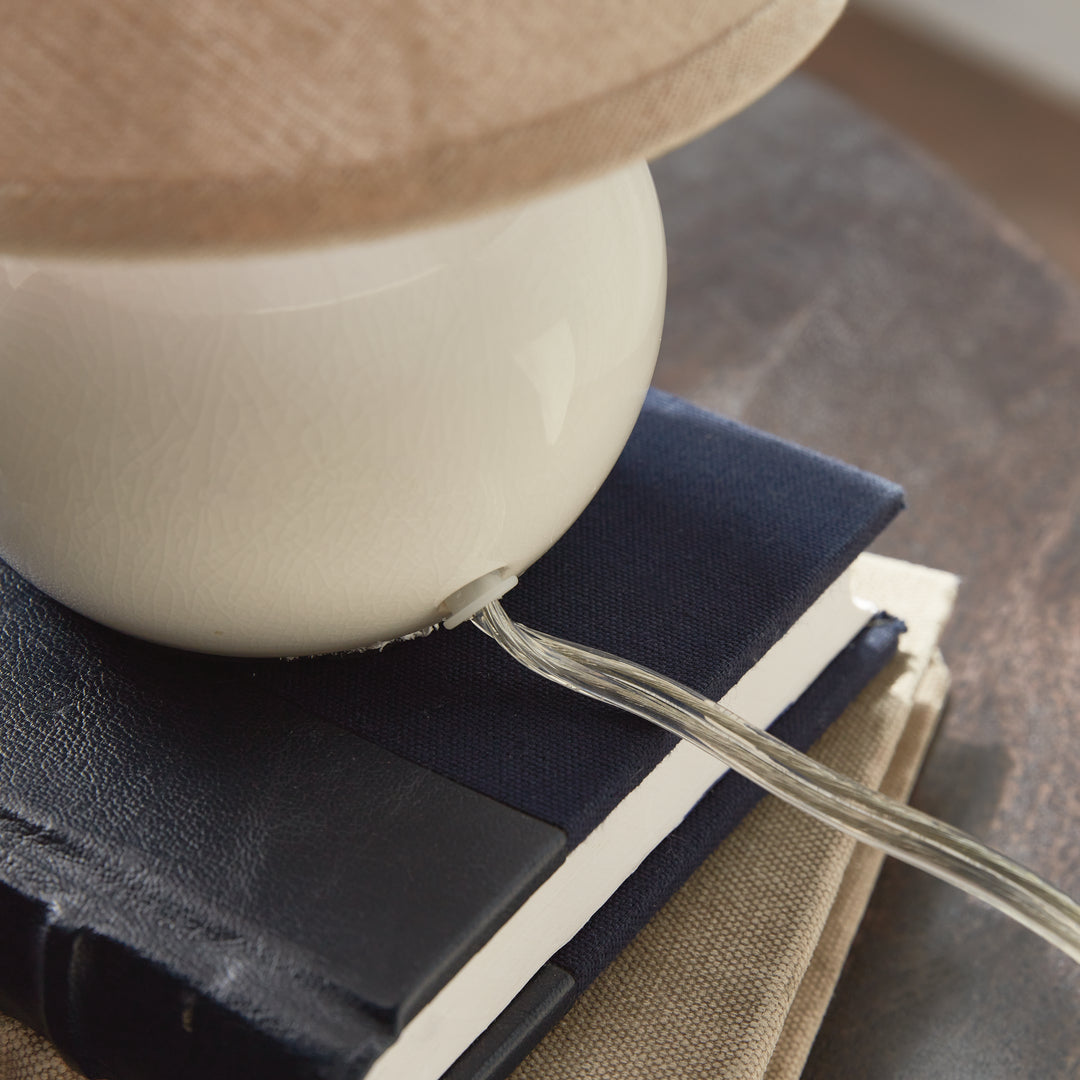White ceramic mini table lamp rear close-up showing crackle glaze and the clear lamp cord at its base - Coastal Transitional