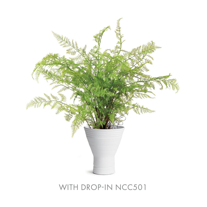 Fluted white ceramic vase holding faux fern drop-in NCC501, sculptural matte form with soft green foliage – Modern Organic.

