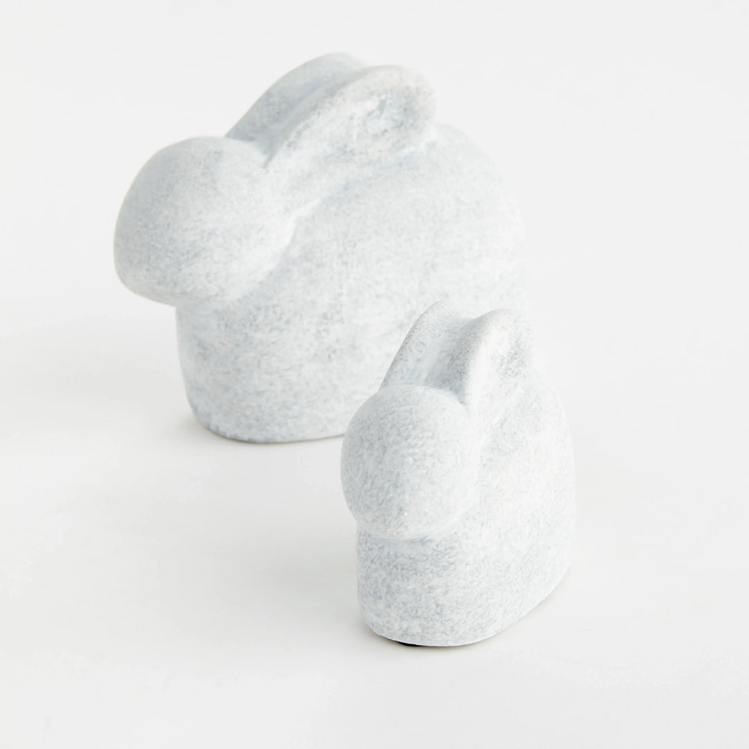 Two white concrete rabbit sculptures shown from the side with rounded forms and a softly graywashed finish – Modern Organic.