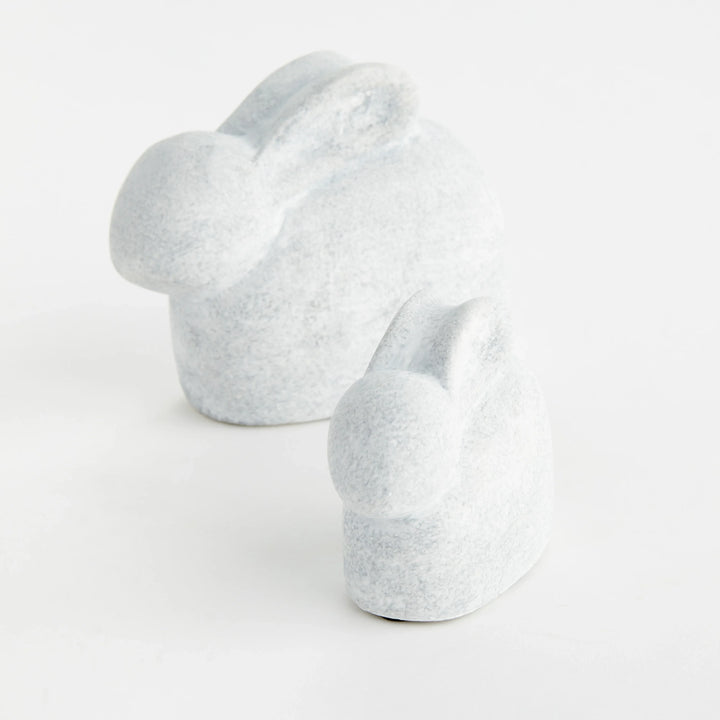 Two white concrete rabbit sculptures shown from the side with rounded forms and a softly graywashed finish – Modern Organic.
