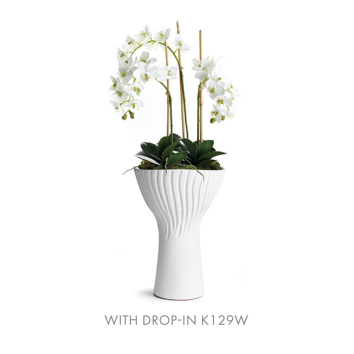Tall fluted white ceramic vase styled with orchid drop-in K129W