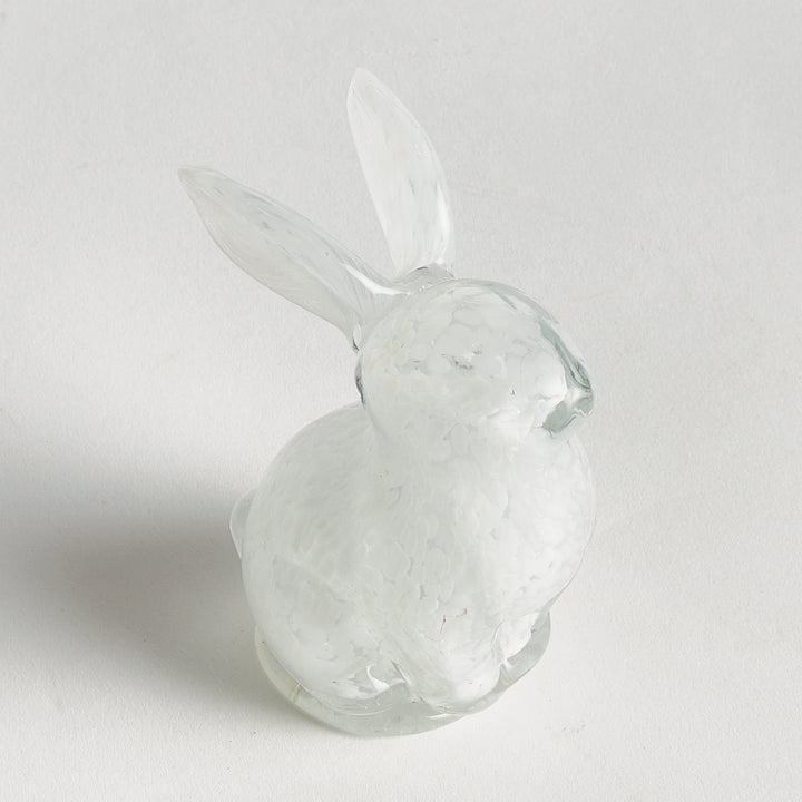 Side view of hand blown white glass bunny sculpture showing sculptural silhouette and smooth finish for refined tabletop styling.