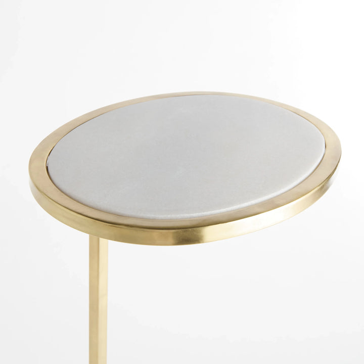 White oval marble top accent table with gold metal rim and slim support shown close detail Modern Glam style