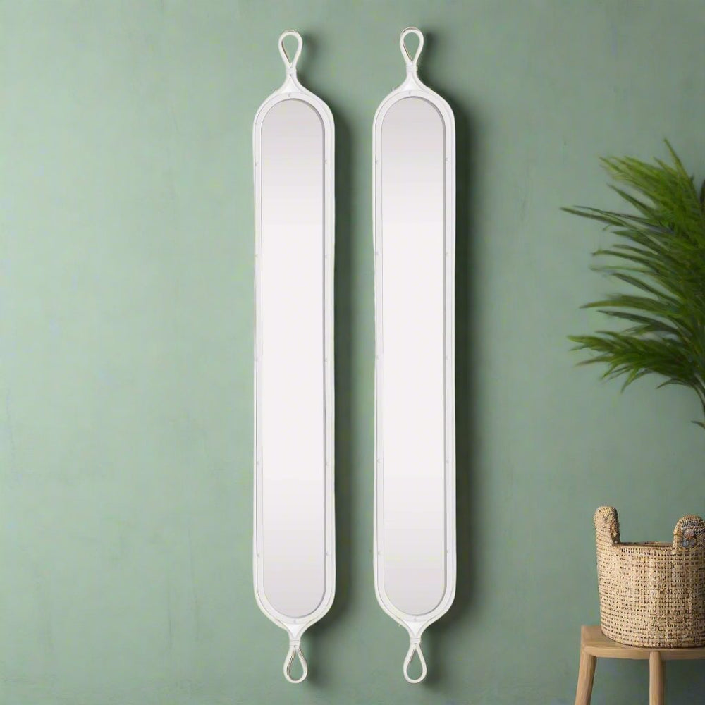 Coastal styling of French loop mirrors against green wall with natural textures, ideal for narrow entryways or modern small spaces.



