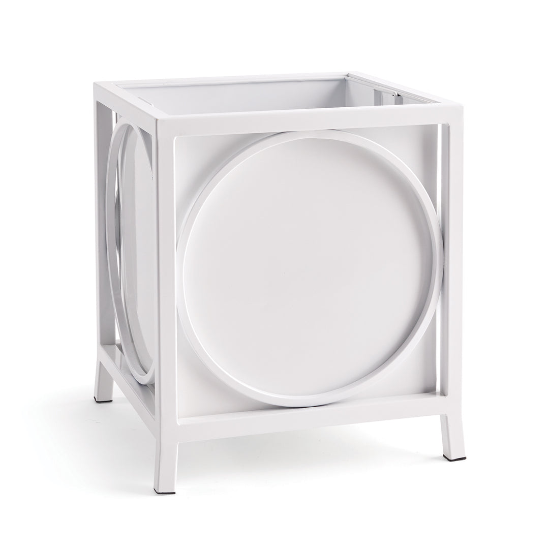 White iron planter with circular side panels, shown at angle in modern coastal style.
