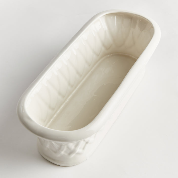 Overhead view into a white oblong ceramic cachepot with rounded ends and an elongated open interior on white, Traditional