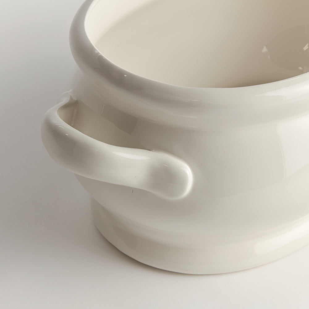 White oval ceramic cachepot close-up showing a loop handle, curved rim and smooth glossy surface in detail - Traditional