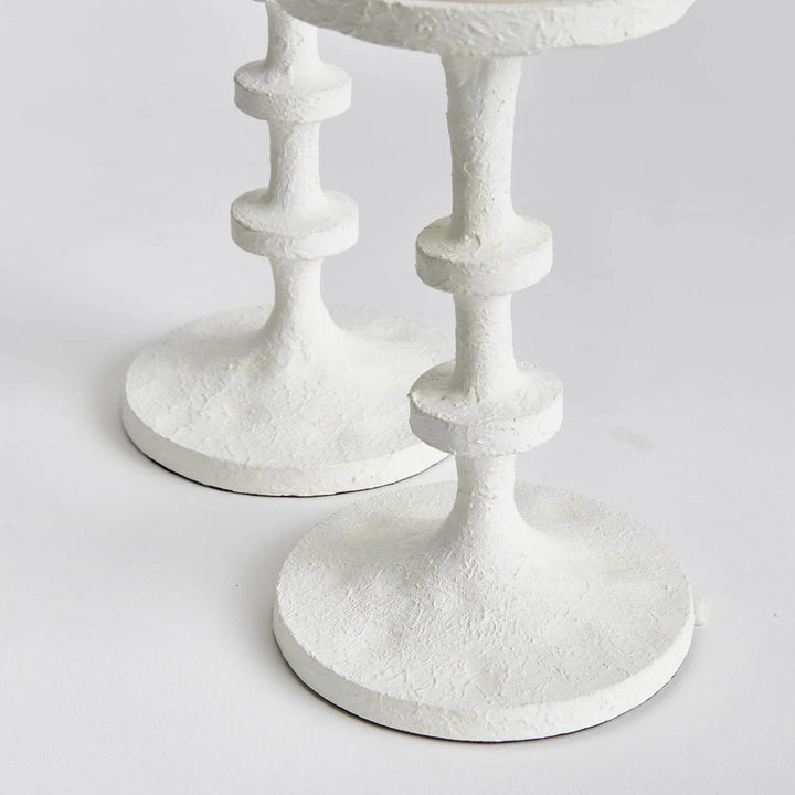 Detailed side view of two white petite candle stands with stacked stems and round bases on a tabletop surface – Modern Farmhouse.