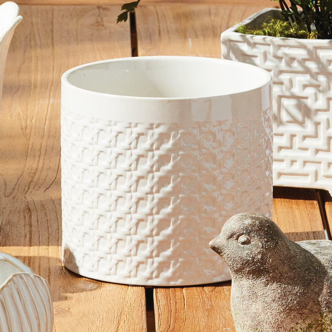 White round lattice ceramic planter styled on a wooden tabletop beside a decorative bird and a square planter, Traditional