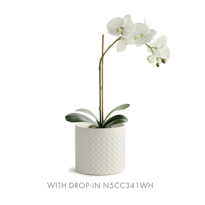 White round lattice ceramic planter with a white orchid drop-in, its broad leaves resting above the shaped body, Traditional