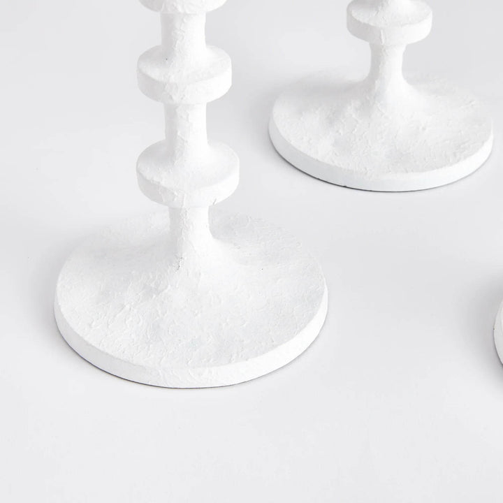 Close-up of white taper candle holder base showing textured surface and round support for flameless candles – Modern Farmhouse.