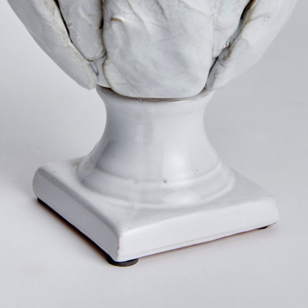 Small white terracotta artichoke finial detail showing the curved stem and square base beneath layered leaves - Traditional