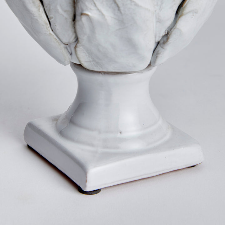 Small white terracotta artichoke finial detail showing the curved stem and square base beneath layered leaves - Traditional