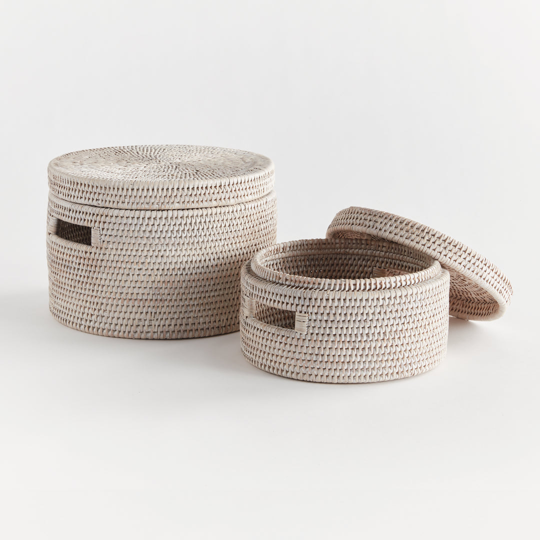 Whitewash rattan boxes with one lid removed, showing the woven interior and graduated sizes on white, Coastal Transitional