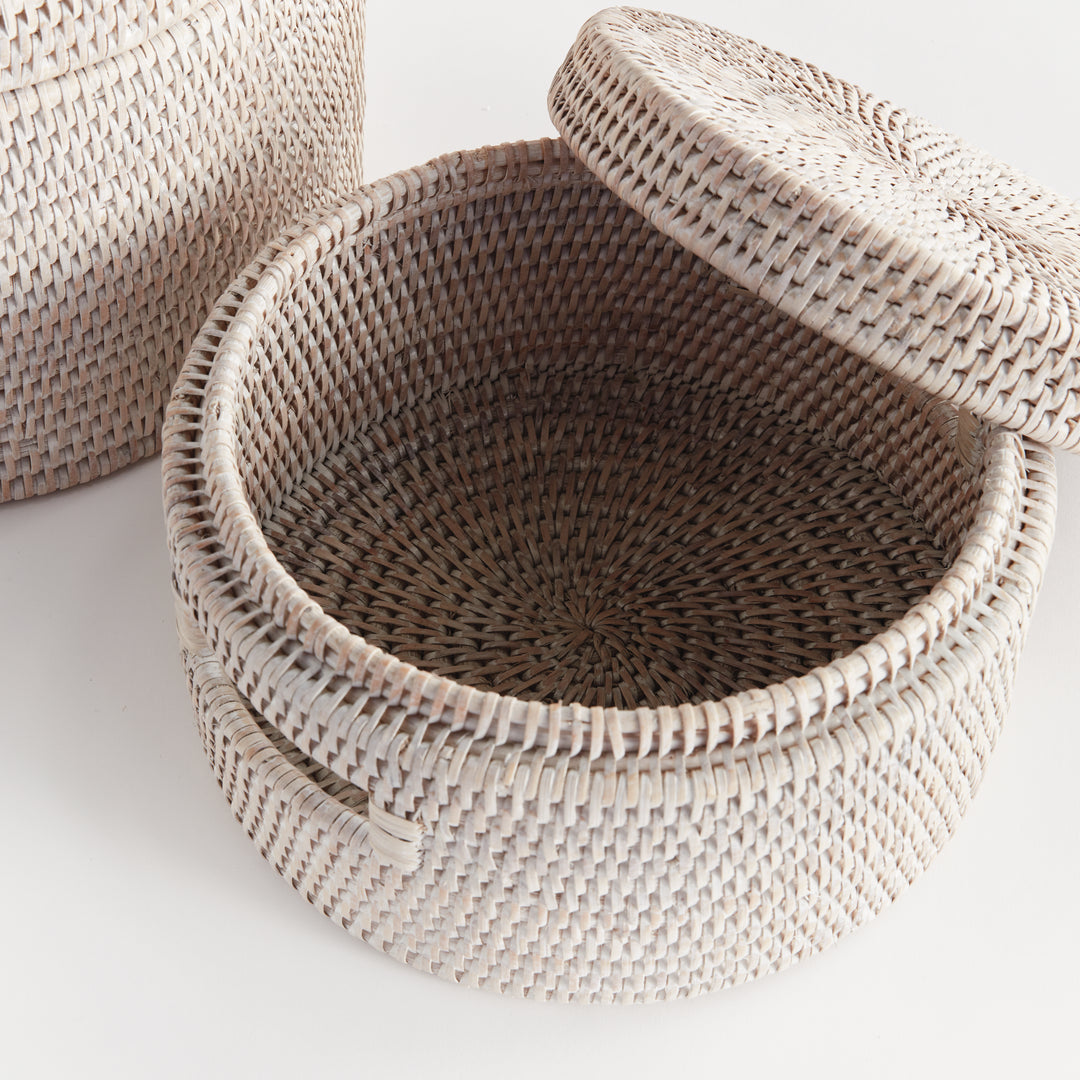 Overhead view into an open whitewash rattan box with a woven interior and its matching round lid lifted, Coastal Transitional