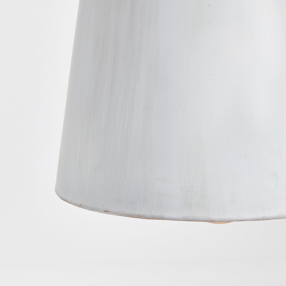 Close view of a whitewashed iron bottle pendant shade, showing the varied matte surface and lower edge, Transitional style