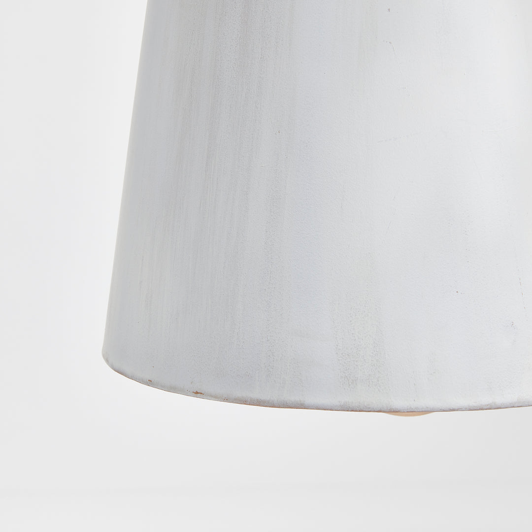 Close view of a whitewashed iron bottle pendant shade, showing the varied matte surface and lower edge, Transitional style