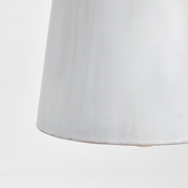 Close view of a whitewashed iron bottle pendant shade, showing the varied matte surface and lower edge, Transitional style