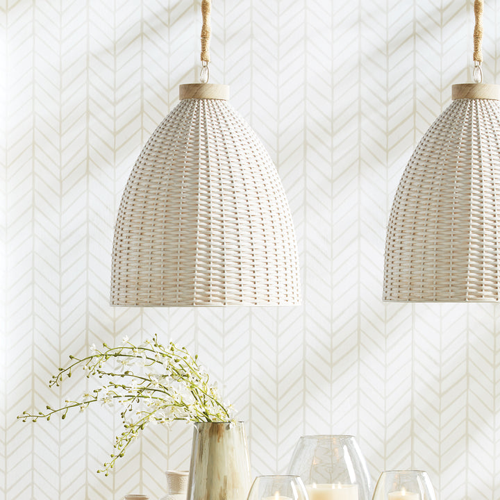 Whitewashed rattan pendant pair above a dining table with clear glassware, greenery and patterned walls, Transitional style