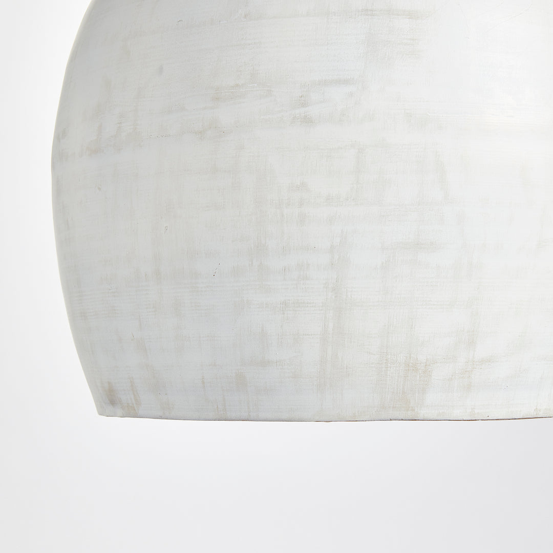Rounded whitewashed iron pendant shade close-up, showing pale tonal variation and a curved lower edge, Transitional style