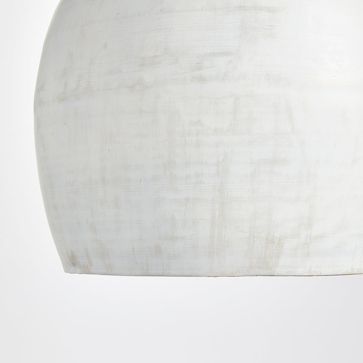 Rounded whitewashed iron pendant shade close-up, showing pale tonal variation and a curved lower edge, Transitional style