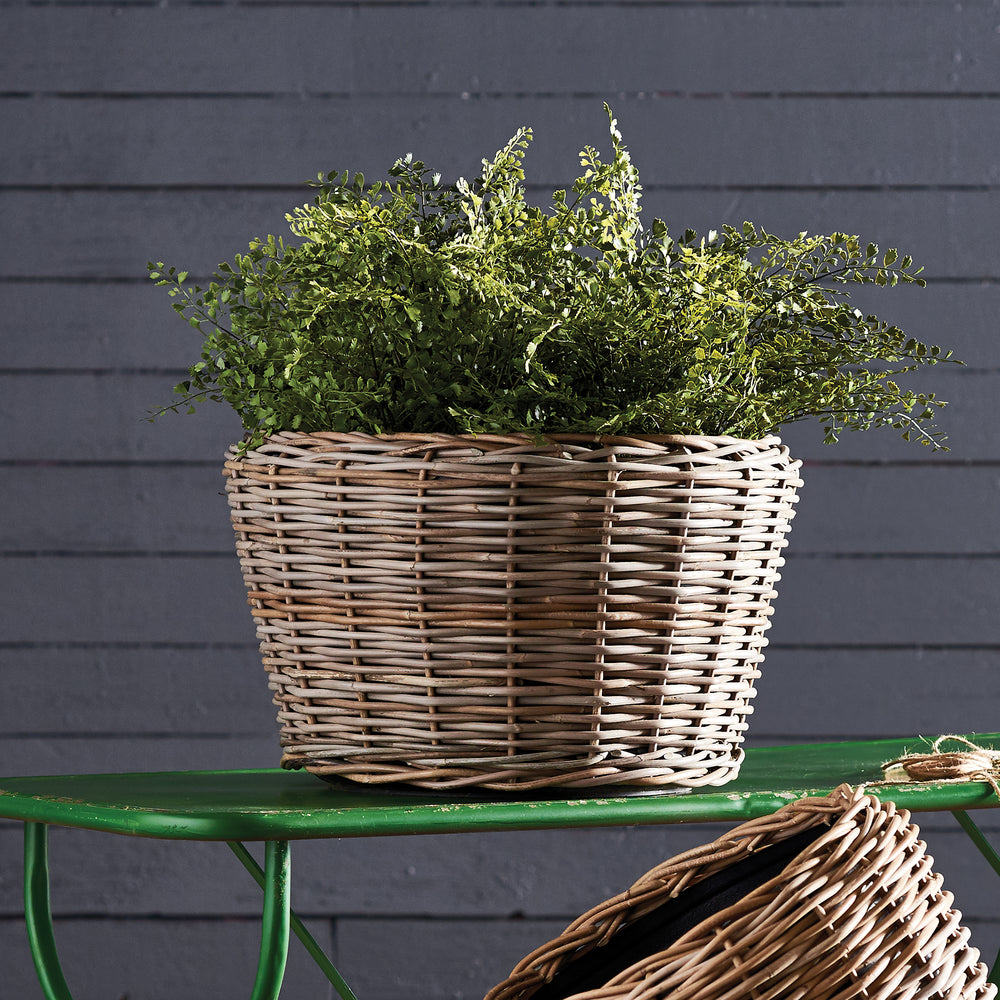 Close-up of woven rattan planter texture with plastic liner, natural boho chic design

