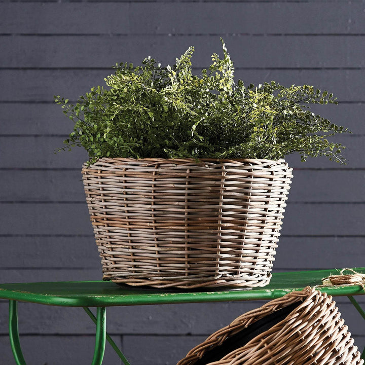 Close-up of woven rattan planter texture with plastic liner, natural boho chic design

