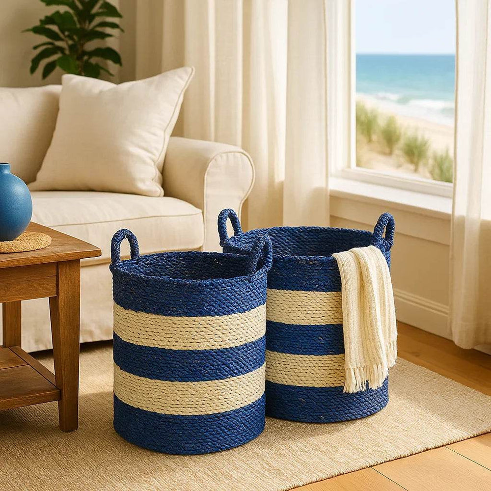 Blue and white seagrass storage baskets styled in a coastal living room with light wood accents.