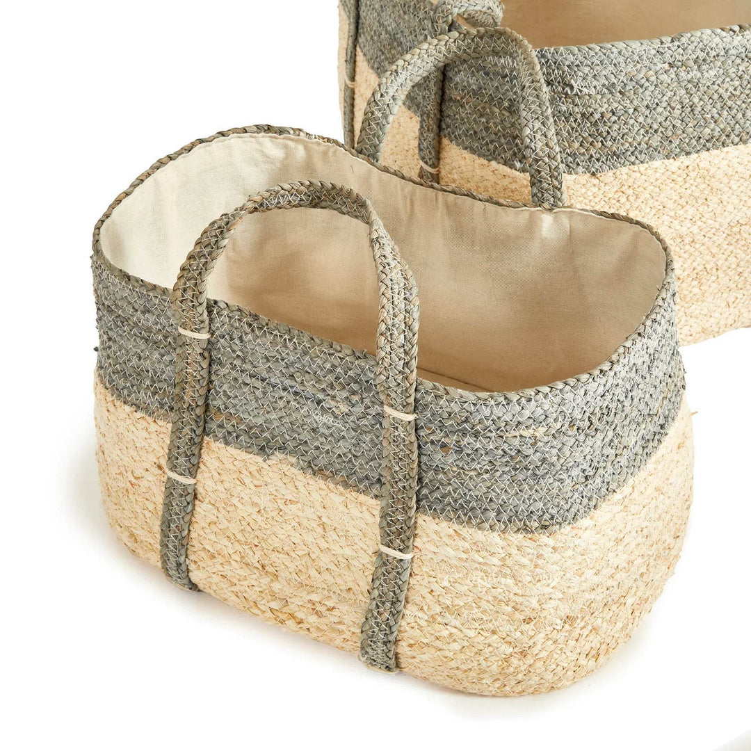Close-up of woven rectangular storage baskets with cotton liner, gray and natural tones, used for entryway or living room storage.

