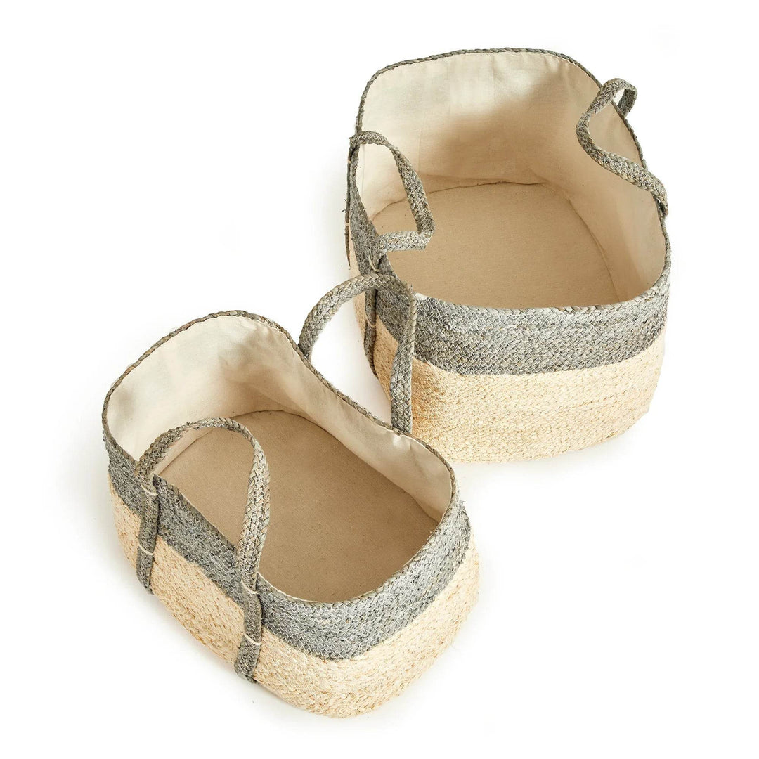 Woven rectangular storage baskets with handles, gray and natural corn husk weave, indoor storage solution for blankets or toys.

