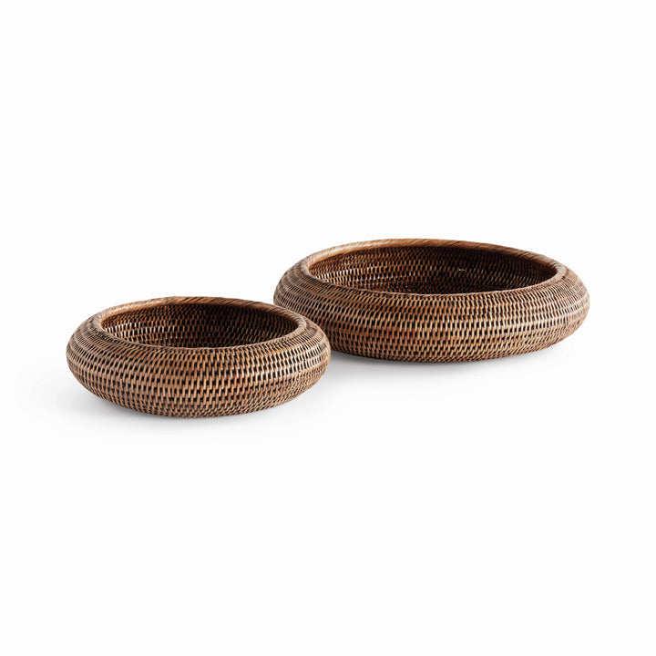 Brown rattan shallow display bowls in two sizes with rounded sides and thick rims, shown on white - Coastal Transitional