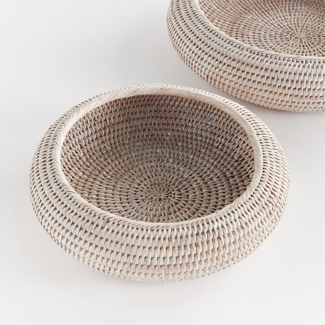 Whitewash rattan shallow display bowls in overhead view, showing circular woven bases and rounded rims - Coastal Transitional