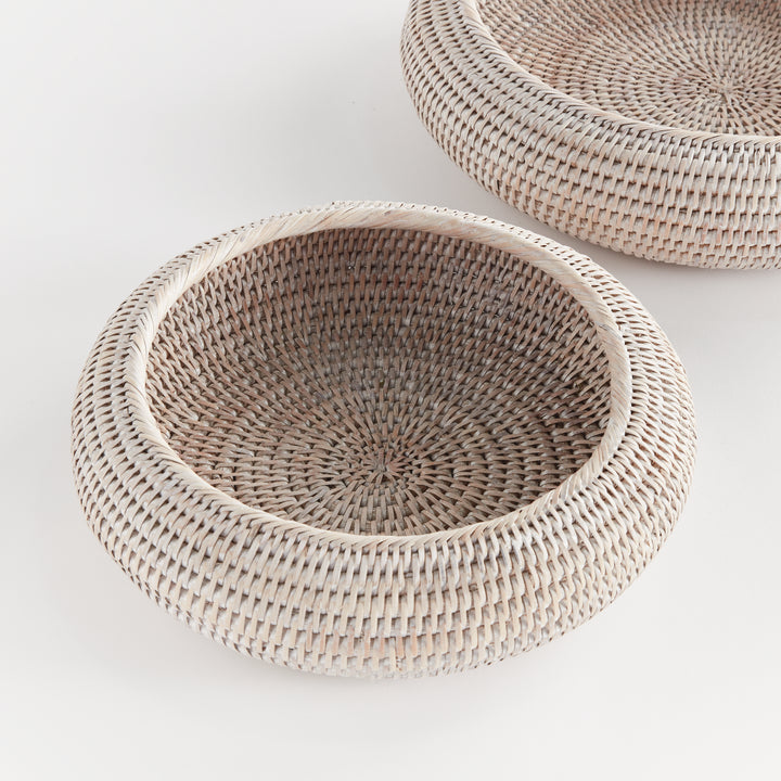 Whitewash rattan shallow display bowls in overhead view, showing circular woven bases and rounded rims - Coastal Transitional