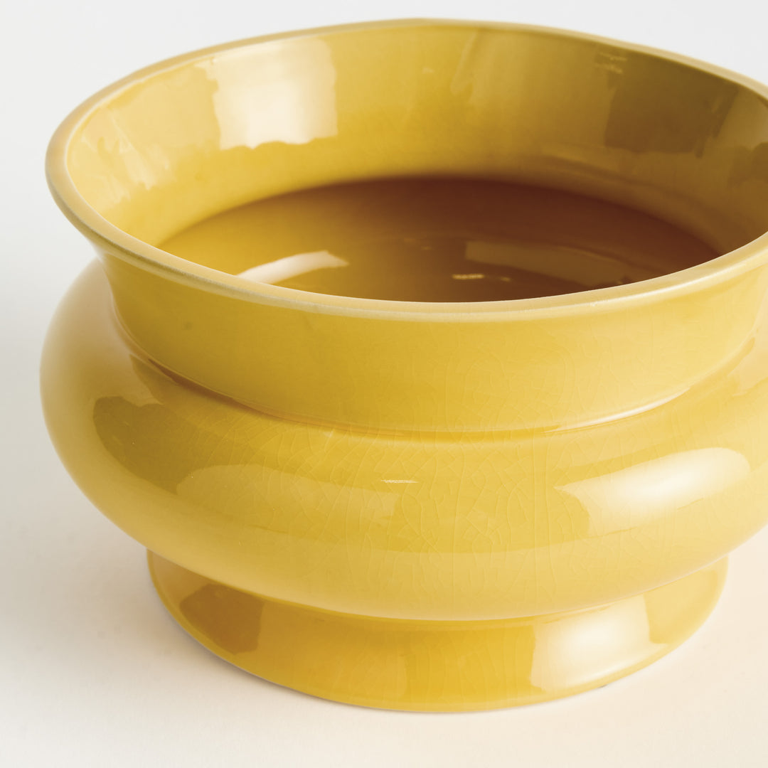 Yellow wide ceramic cachepot with glossy reactive glaze and broad rounded profile shown from an alternate angle – English Country